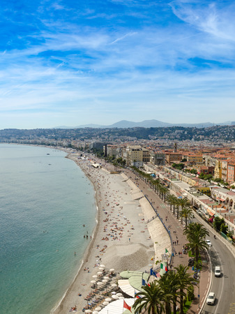Luxury resort of French riviera. Beautiful panorama city of Nice in France. Sunny, summer day. Mediterranean sea, public beach, famous quay, palms and houses of Niceの写真素材