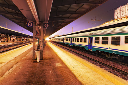 Train at railway station in Venice, Italy at sunsetの写真素材