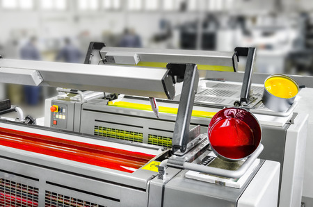 Offset print machine printing unit magenta and yellow with color potsの写真素材