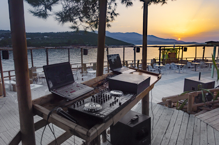 Summer beach party empty dj stage and equipment at sunsetの写真素材