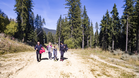 Group of people walking in summer mountainsの写真素材