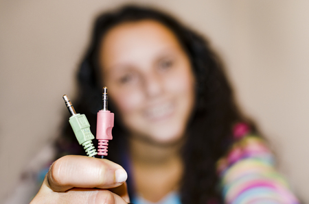 Happy girl showing wire pin connectorsの写真素材