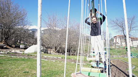 Teen girl on the ropes in adventure parkの写真素材