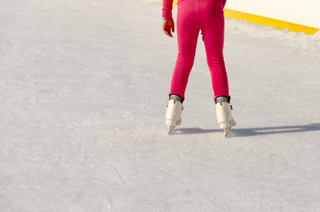 Girl legs in ice skates hockey and figure skatingの写真素材