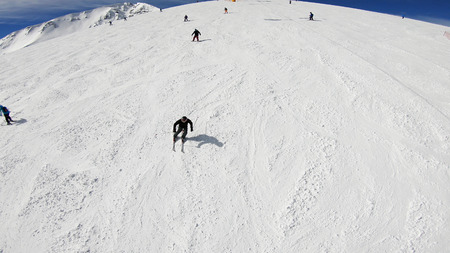 POV of skiier riding the chairlift during a sunny winter day