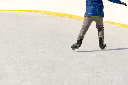 Close-up of ice skating shoes on a rinkの写真素材
