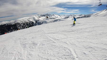 Skiing, winter, ski vacation - young boy skiing down, fun on mountainsideの写真素材