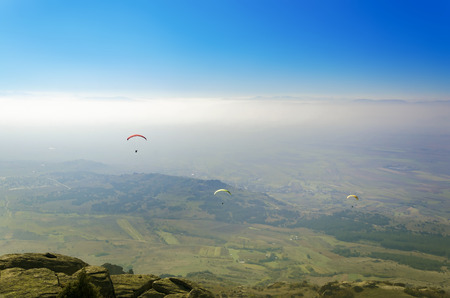 Paraglider pilot pov of people paragliding over the valleyの写真素材