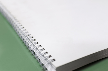 White notebook with spiral, selective focus dof background, office conceptの写真素材