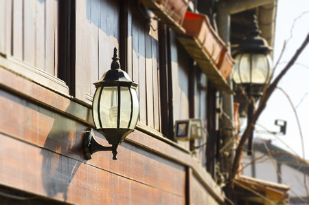 Old street lamp in traditional wooden balcony in Bansko, Bulgariaの写真素材
