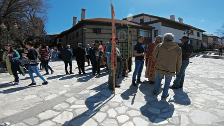 Bansko, Bulgaria - April 06, 2018: Easter parade ceremony on streets in Bansko, Bulgaria. Priests and people traditionally walk down the streets singing religious songs and giving Easter eggs to childrenのeditorial素材