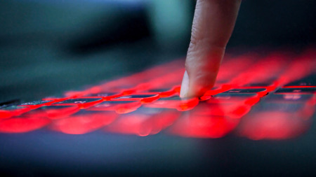Close up on Business woman Hands typing on lighting keyboardの写真素材