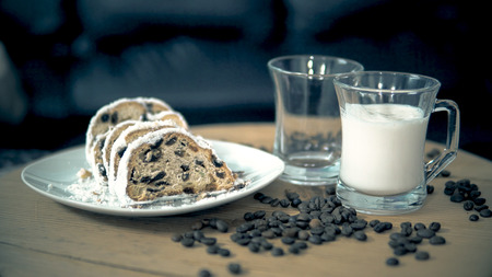 Pouring a cup of milk and french chocolate coffee cake on breakfastの写真素材