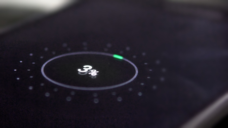 Low battery. Mobile smart phones charging on wooden desk. Cinematic dofの写真素材