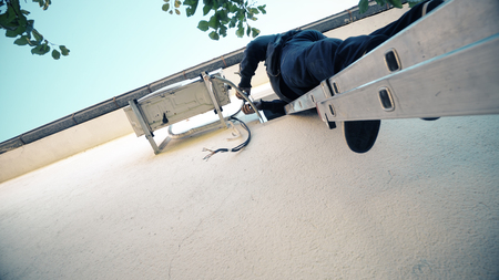 Techican man electrician installing air conditioning in a client house, cinematic steadicam shotの写真素材
