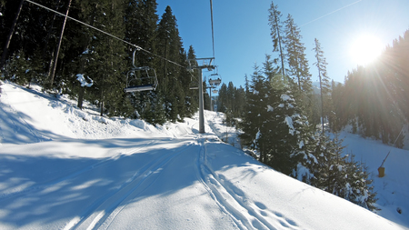 Mountains landscape pov with ski slopes and ski lifts on sunny day at mountain summit Todorka in Bansko  ski resort in Bulgariaの写真素材