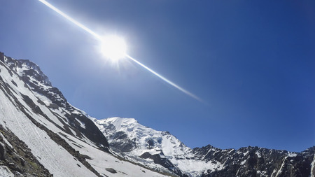 Mont Blanc, Chamonix, French Alps. France, Climber pov from helmet mounted camera to mountain massiff against blue sky and sun shiningの写真素材