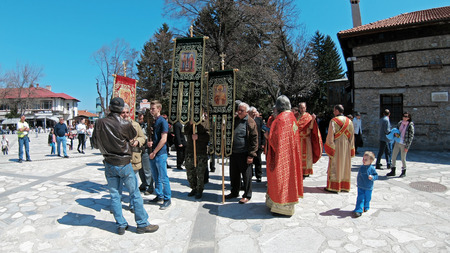 Bansko, Bulgaria - April 06, 2018: Easter parade ceremony on streets in Bansko, Bulgaria. Priests and people traditionally walk down the streets singing religious songs and giving Easter eggs to childrenのeditorial素材
