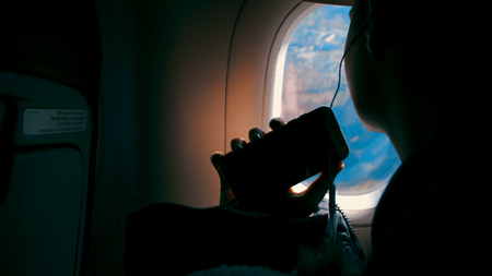 Happiness of asian girl with headphone listening music and taking pictures with smartphone and...