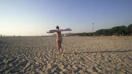 Beautiful Girl With White Scarf on The Beach. Travel and Vacation. Freedom Conceptの写真素材