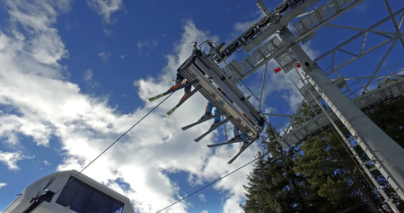 Skier and snowboarder riding up to the top of the mountainの写真素材