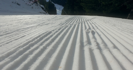 Snow lines made from a snow machine on a ski slope, cinematic steadicam shotの写真素材