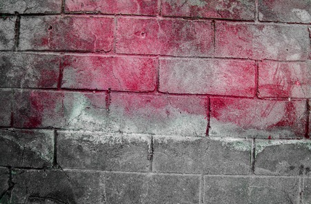 Fragment of old dirty brick wall with peeling plaster texture white grey brown black green blue lime yellow orange maroon violet pink turquoise, stone surface with cracks, useful as background tonedの写真素材