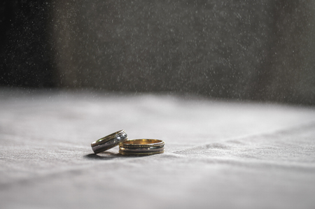 Wedding love concept. 2 golden wedding rings on textile toned background. Selective focusの写真素材