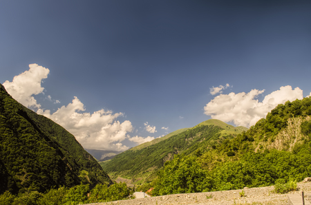 Beautiful summer landscape in mountains, green meadows and the dark blue sky with clouds . Big Caucasus. Azerbaijan. Gakh. Ilisuの写真素材