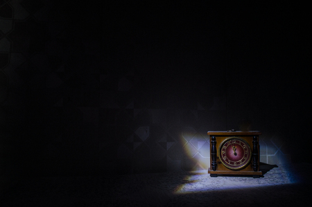 Time concept - vintage wood clock face with grunge texture at dark red maroon curtain background,の写真素材