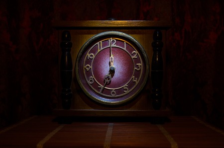 Time concept - vintage wood clock face with grunge texture at dark red maroon curtain background,の写真素材