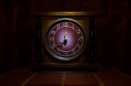 Time concept - vintage wood clock face with grunge texture at dark red maroon curtain background,の写真素材