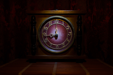 Time concept - vintage wood clock face with grunge texture at dark red maroon curtain background,の写真素材