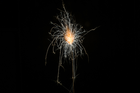 Golden orange amazing fireworks isolated in dark background close up, New Year, explodeの写真素材
