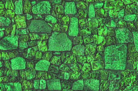 Fragment of old brick wall with river stones texture white grey brown black green blue lime yellow orange maroon violet pink turquoise colored background, different type of stones mosaic surfaceの写真素材