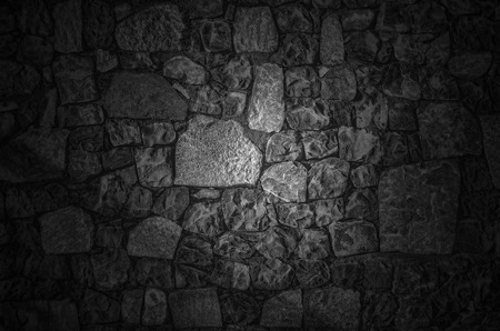 Fragment of old brick wall with river stones texture white grey brown black green blue lime yellow orange maroon violet pink turquoise colored background, different type of stones mosaic surfaceの写真素材