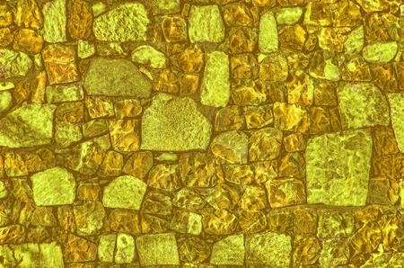 Fragment of old brick wall with river stones texture white grey brown black green blue lime yellow orange maroon violet pink turquoise colored background, different type of stones mosaic surfaceの写真素材