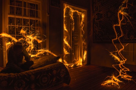 Abstract fireworks flame freezelight on window. Apartment building on Fire at Night time. Fire conceptの写真素材