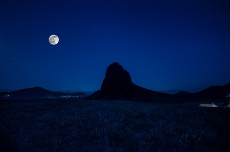 Beautiful night landscape of alone Goyezen mountain at night with big full moon. Field and mountain slope at night in moon light. Azerbaijan big Caucasus, Gazakhの写真素材