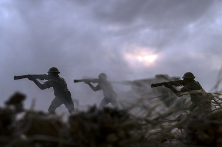 War Concept. Military silhouettes fighting scene on war fog sky background, World War Soldiers Silhouettes Below Cloudy Skyline At Dusk or Dawn. Attack sceneの写真素材