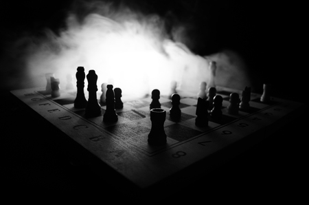 chess board game concept of business ideas and competition and strategy ideas concep. Chess figures on a dark background with smoke and fog. Selective focusの写真素材