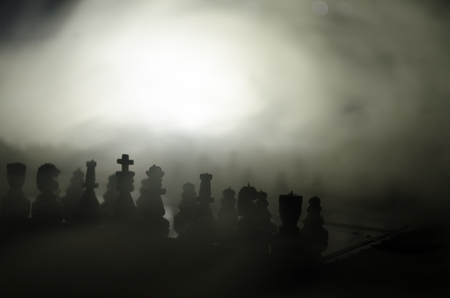 chess board game concept of business ideas and competition and strategy ideas concep. Chess figures on a dark background with smoke and fog. Selective focusの写真素材