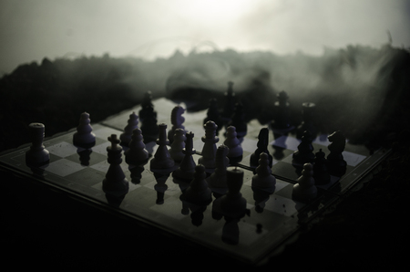 chess board game concept of business ideas and competition and strategy ideas concep. Chess figures on a dark background with smoke and fog. Selective focusの写真素材
