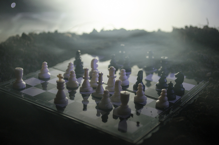chess board game concept of business ideas and competition and strategy ideas concep. Chess figures on a dark background with smoke and fog. Selective focusの写真素材
