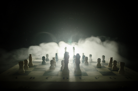 chess board game concept of business ideas and competition and strategy ideas concep. Chess figures on a dark background with smoke and fog. Selective focusの写真素材