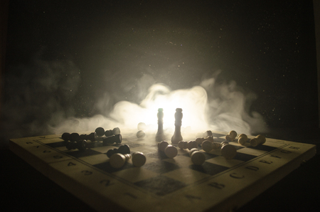 chess board game concept of business ideas and competition and strategy ideas concep. Chess figures on a dark background with smoke and fog. Selective focusの写真素材