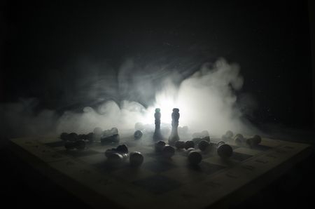 chess board game concept of business ideas and competition and strategy ideas concep. Chess figures on a dark background with smoke and fog. Selective focusの写真素材