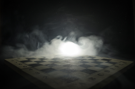 chess board game concept of business ideas and competition and strategy ideas concep. Chess figures on a dark background with smoke and fog. Selective focusの写真素材