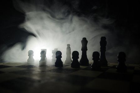 chess board game concept of business ideas and competition and strategy ideas concep. Chess figures on a dark background with smoke and fog. Selective focusの写真素材