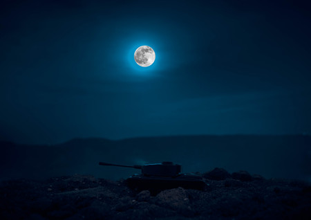 War Concept. Military silhouettes fighting scene on war fog sky background, World War Soldiers Silhouettes Below Cloudy Skyline At night. Attack scene. Armored vehicles. Tanks battle. Decorationの写真素材